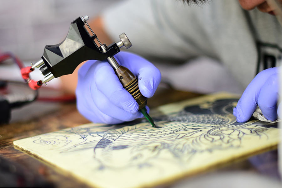 Unable to hear or talk, tattoo artist creates magic with hands